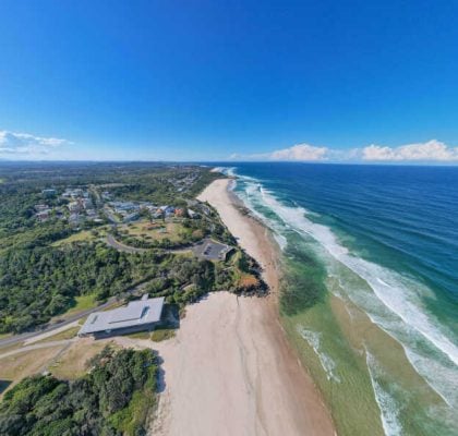 Aerial-View-of-a-Long-Coastal-Beach-and-Headland