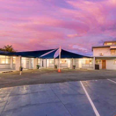 Motel exterior at sunset with vibrant skies.