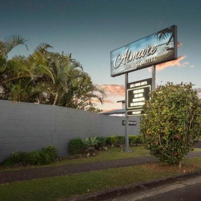 A beautiful twilight view of the 'Almare Tourist Motel' entrance from the street.