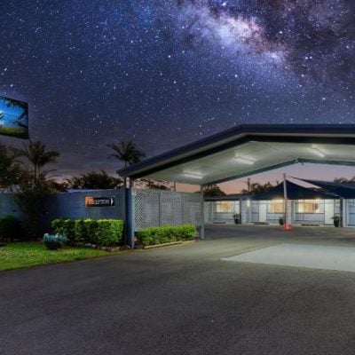 A dramatic nighttime photo of the 'Almare Tourist Motel' entrance under a starry sky showing the bright Milky Way.