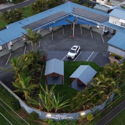 An aerial nighttime or dusk view of the 'Almare Tourist Motel' complex.