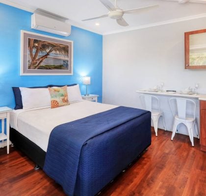 coastal themed motel room with kitchenette